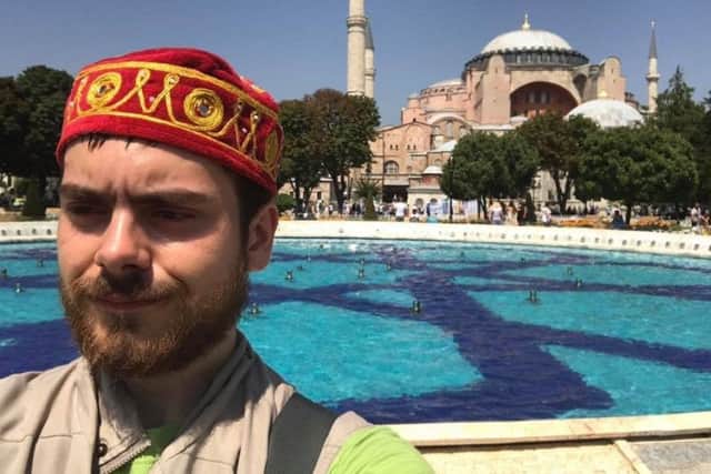 Peter Randall sporting the red and gold hat he bought during an extended stop-off in Istanbul