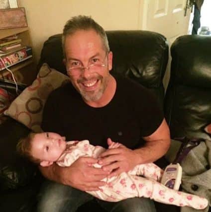 Brad Olson pictured with little Olivia Butler.
