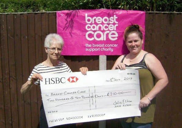 Julie Elton, right, hands the cheque to Nikki's mum, Ann EMN-170731-101353001