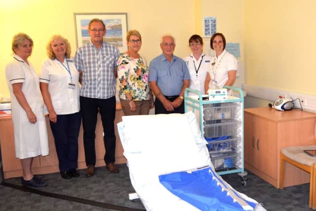 Jean Clarks husband Brian Clark (third from right), brother Brian Chudley (third from left) and sister-in-law Pam Chudley (centre) pictured with staff from Lymphoedema Clinic at Lindsey Lodge Hospice. EMN-170108-123804001
