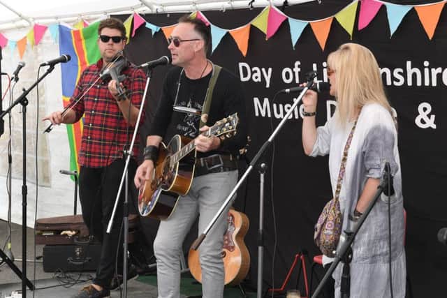 Day of Lincolnshire Folk, Music, Dance and Song at The George Hotel, Leadenham. Band From County Hell performing on the George Hotel Yard Stage. EMN-170708-131530001