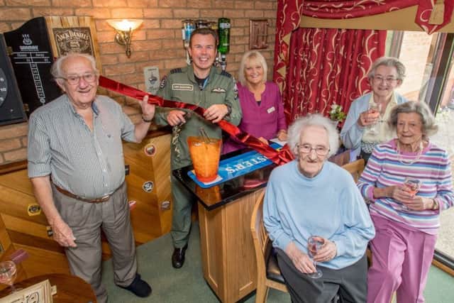 Group Captain Mike Baulkwell and Julie Harrison (manager) with residents at the opening. Photo: John Aron.