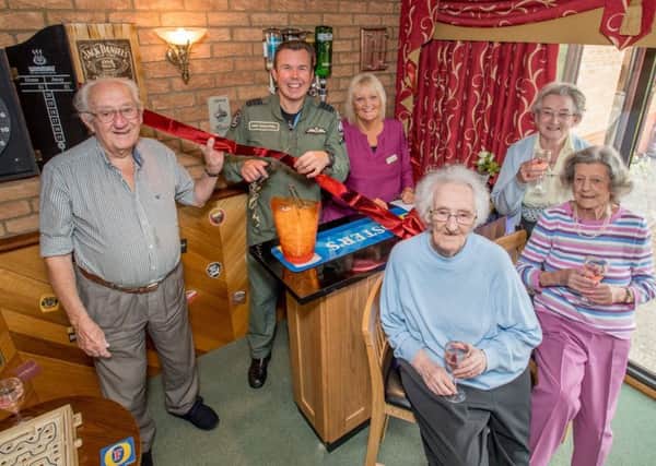 Group Captain Mike Baulkwell and Julie Harrison (manager) with residents at the opening. Photo: John Aron.
