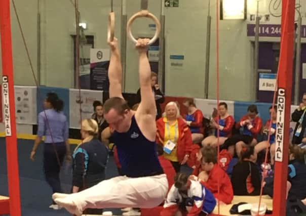 Gymnast Andrew McLaughlin powering his way to a  bronze medal on the rings at the Summer Games in Sheffield EMN-170814-225337001