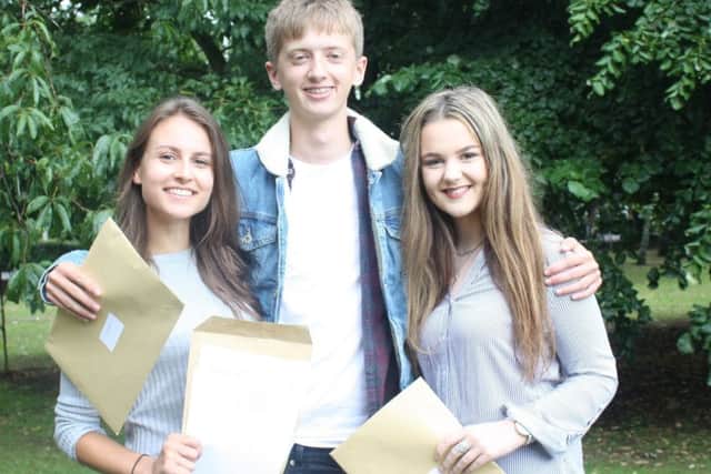 Students at Queen Elizabeths Grammar School celebrating their A-Level results.  Pictured (left to right) Maya Taylor, William Smalley and Sophie Brackenbury.