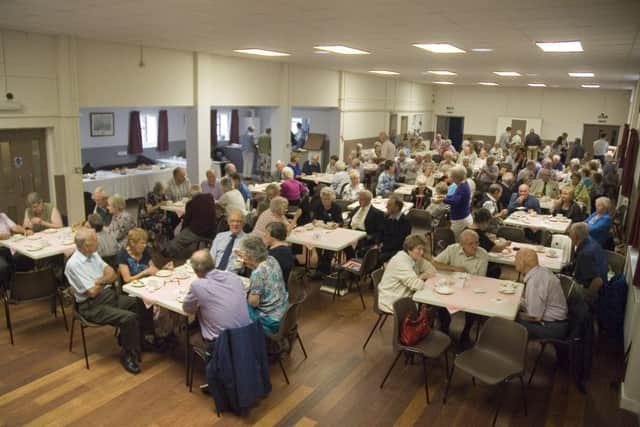 The capacity audience sit down to enjoy their cream tea EMN-170609-115232001