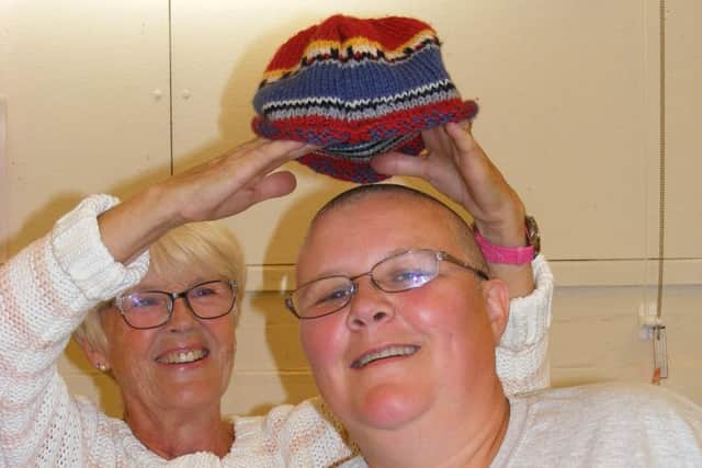 Nicola Hobday after braving the shave, with mum Rita offering something to keep her head warm! EMN-170809-163742001