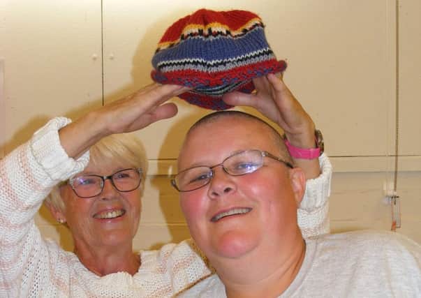 Nicola Hobday after braving the shave, with mum Rita offering something to keep her head warm! EMN-170809-163742001