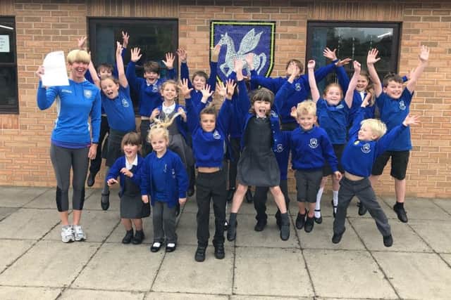 Winchelsea School headteacher Helen Duckett and pupils celebrate their latest Ofsted report. EMN-170918-142551001
