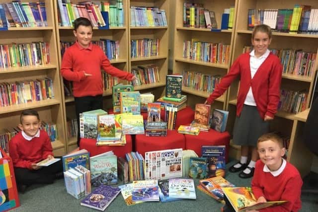 All smiles: Youngsters at St Michael Primary School with some of their books