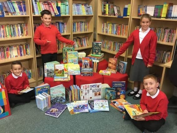 All smiles: Youngsters at St Michael Primary School with some of their books