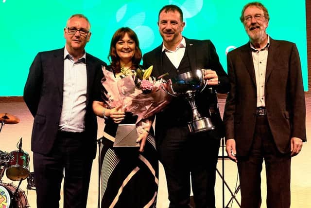 Rachael Hockmeyer and Christian Slingsby (centre) of Hockmeyer Motors receive their Baldwin Trophy award at the Spar Retail Show. EMN-170913-110929001