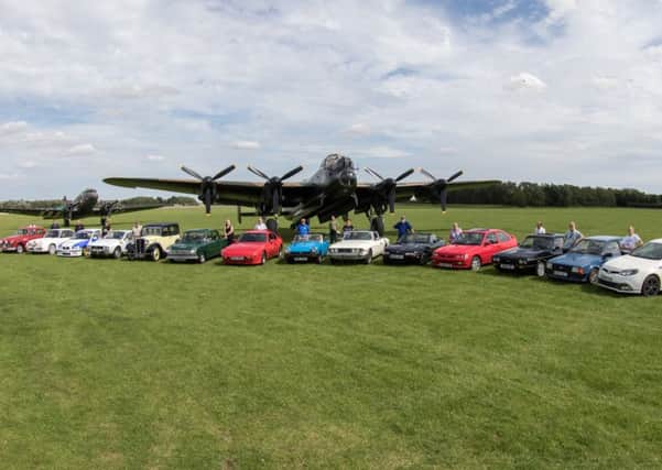 Just some of the motor club members who recently took part in a photoshoot at the Lincolnshire Aviation Hertiage Museum in East Kirkby.