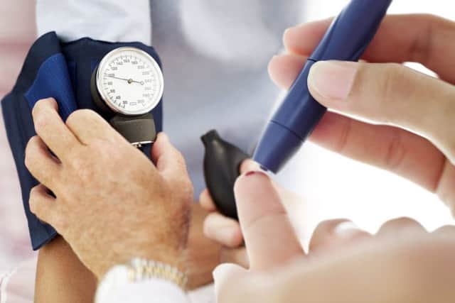 Blood pressure checks on a patient.