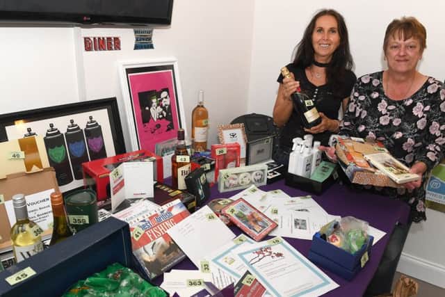Carl Panton Memorial Day charity fishing match at White House Farm, North Kyme. Debbie Curtis - owner of White House Farm, Linnie Woolerton with raffle prizes.