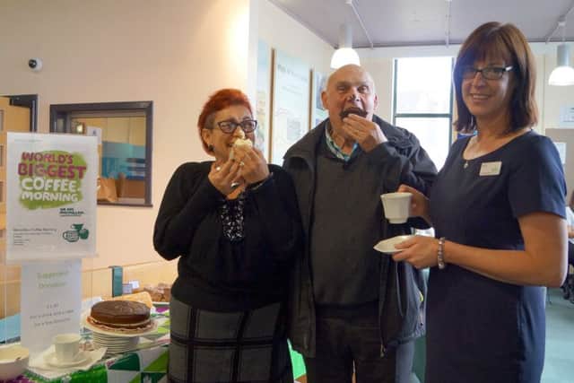 Sharon Chambers and Richard Barker tuck in to some of the tasty cakes with library customer service assistant Donna Starling EMN-170924-204428001