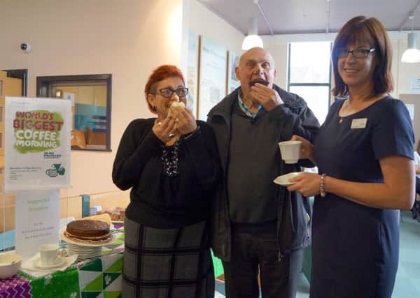 Sharon Chambers and Richard Barker tuck in to some of the tasty cakes with library customer service assistant Donna Starling EMN-170924-204428001