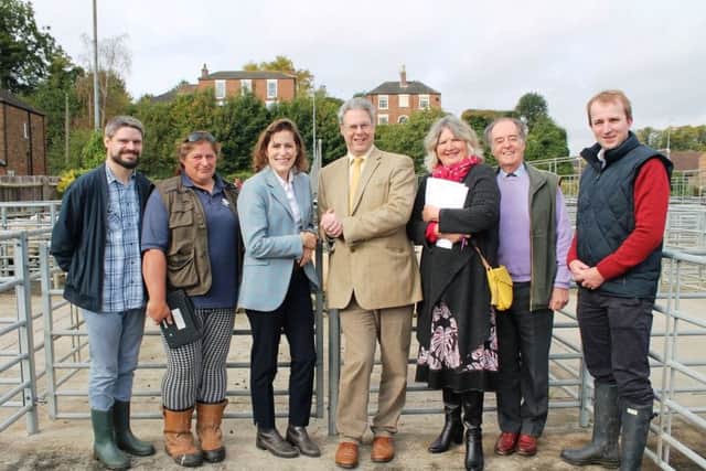Victoria Atkins MP alongside farmers, officials, and councillors.