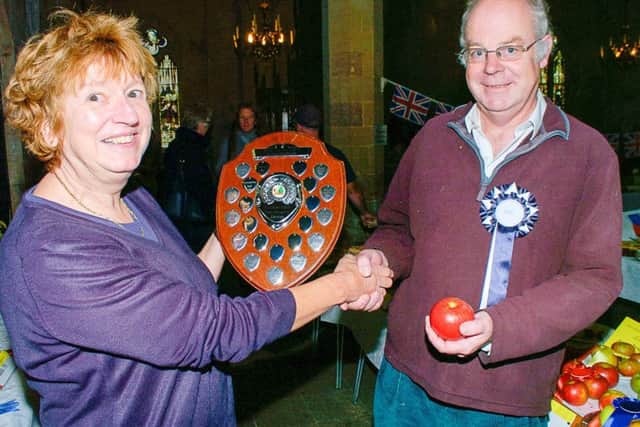 Janet Salmon, Brant Broughton parish councillor presents first prize for apples to Charlie Thornton of Brant Broughton. EMN-170925-155938001