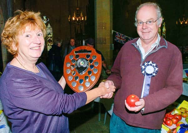 Janet Salmon, Brant Broughton parish councillor presents first prize for apples to Charlie Thornton of Brant Broughton. EMN-170925-155938001