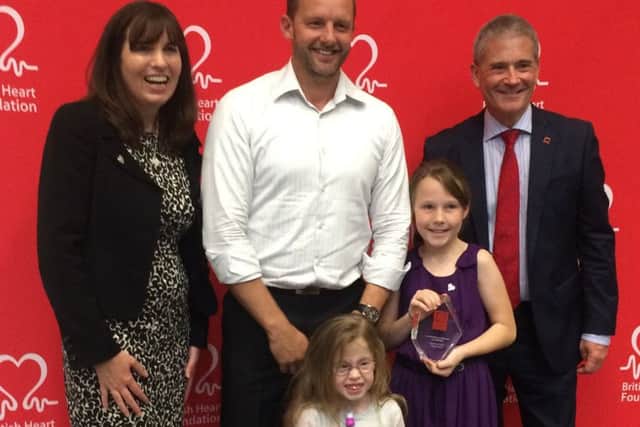 Celebrating winning the Fighting Spirit Award at the BHF's Midlands Supporter Day. Lee Mitchell with daughters Ivy and Lily, of sleaford. EMN-170929-111840001