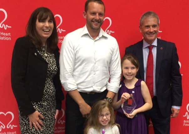 Celebrating winning the Fighting Spirit Award at the BHF's Midlands Supporter Day. Lee Mitchell with daughters Ivy and Lily, of sleaford. EMN-170929-111840001