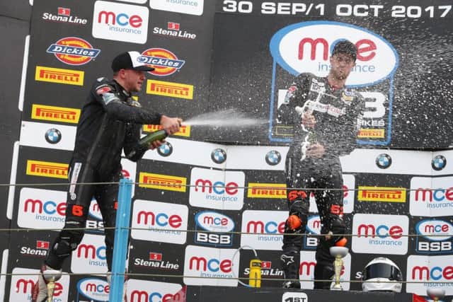 Clarke (left) and Philp celebrate on the podium.