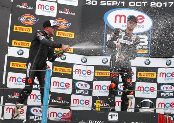 Clarke (left) and Philp celebrate on the podium.