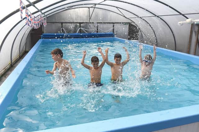 Pupils Charlie Moon, five, Tom Lee, eight, Jack Lee, eight, and George Baker, five, making a splash in the new pool. EMN-170310-112335001