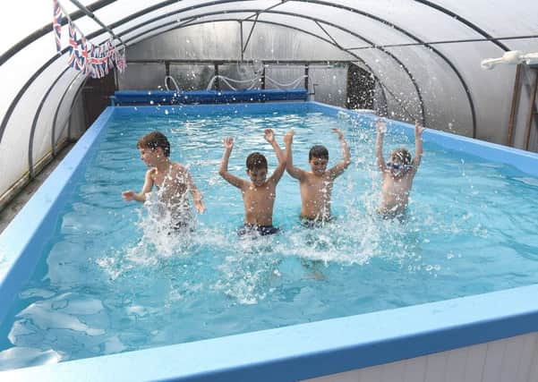 Pupils Charlie Moon, five, Tom Lee, eight, Jack Lee, eight, and George Baker, five, making a splash in the new pool. EMN-170310-112335001