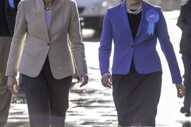 Theresa May and Victoria Atkins
