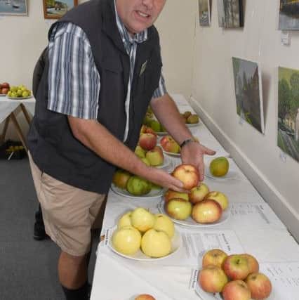 Senior gardener at Gunby Hall Clive Ironmonger with apples from within Gunby Hall gardens.