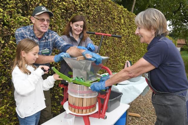 From left, Lacey Holgate, 9, of coningsby, pressing apples with volunteer gardeners Andrew Rowland, Jamielah Lockwood and Lesley Gates.