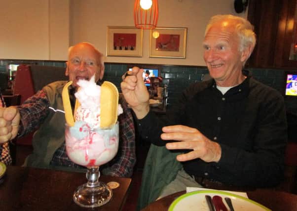 Pictured are Peter Carter (left) with Martin Hanson, who is convincing Martin to try the Helter Skelter sweet. EMN-171020-171044001