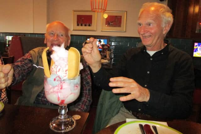 Pictured are Peter Carter (left) with Martin Hanson, who is convincing Martin to try the Helter Skelter sweet. EMN-171020-171044001