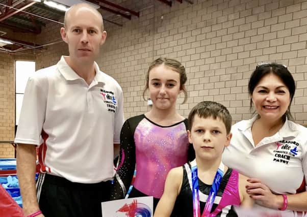 Esmie and Logan with Sleaford Elite Gymastics Club coaches Justin Brown and Patsy Shields EMN-171019-111502002