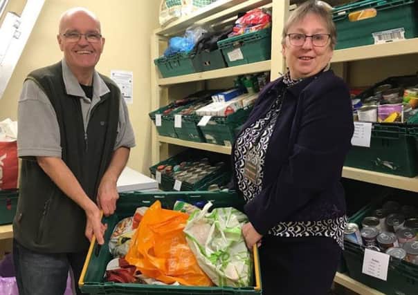The store room at the Storehouse food bank is bursting woth food after the harvest festival, but  stock control volunteer Malcoln Fielder (left) and restore co-ordinator Debby Harland say more donations are needed. ANL-171030-131736001