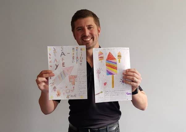 Temporary Coast Insp Matt Bennison with his pick of fireworks posters by Alford Primary School. ANL-171026-123014001