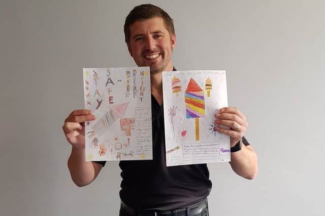 Temporary Coast Insp Matt Bennison with his pick of fireworks posters by Alford Primary School. ANL-171026-123014001