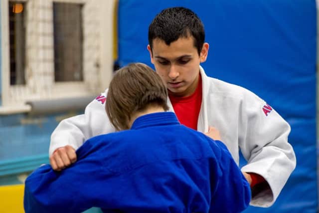 Josh Hicks gets to grips with oppponent Georgina Grayson during a coaching session. Photo: John Aron.