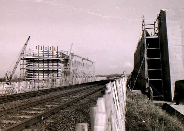 The A15 bypass bridge takes shape over the Sleaford to Grantham railway line in 1992, despite waterlogged conditions for the road constructors. EMN-170211-175724001