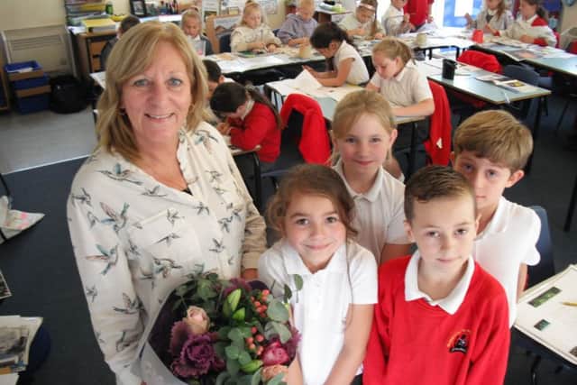 Teaching assistant Heather Wilkins with pupils.