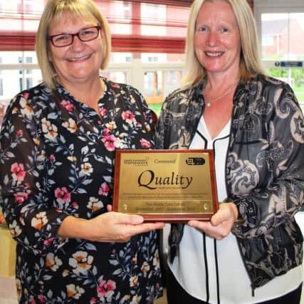 Deputy Manager Denise Cullingford and Regional Manager Caron Davis with the award.