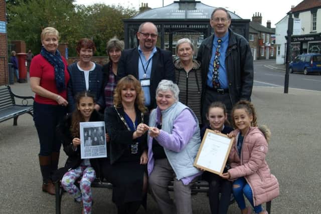 Barbara receives her DofE gold award and badge from Mayor of Alford, Sarah Devereux (centre). They are pictured with other dignitaries and Barbaras family and friends.