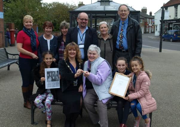 Barbara receives her DofE gold award and badge from Mayor of Alford, Sarah Devereux (centre). They are pictured with other dignitaries and Barbaras family and friends.