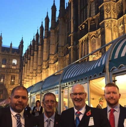The Hildreds team with their award outside the Houses of Parliament.