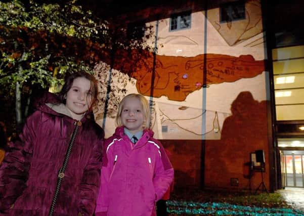 Digital artist Jason Wilsher-Millsand Rauceby school pupils have done a project on The Guinea Pig Club and projecting their work on the side of NCCD. L-R Sharna Tate 10 and Emily Henderson 9. EMN-171011-092240001