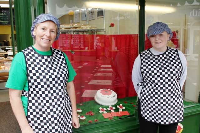 Pocklingtons Bakery staff next to the window display.