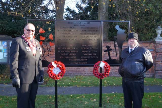 The new memorial in Binbrook, with Ernie Thompson, RAOB wreath layer, and Ian Burgess, Parish Council wreath layer EMN-171211-202236001