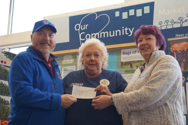 Lions president Gary Eastburn presents £200 to Jenny Stimson and Stella Tuplin, members of the Big Christmas Lunch organising team EMN-171120-084335001